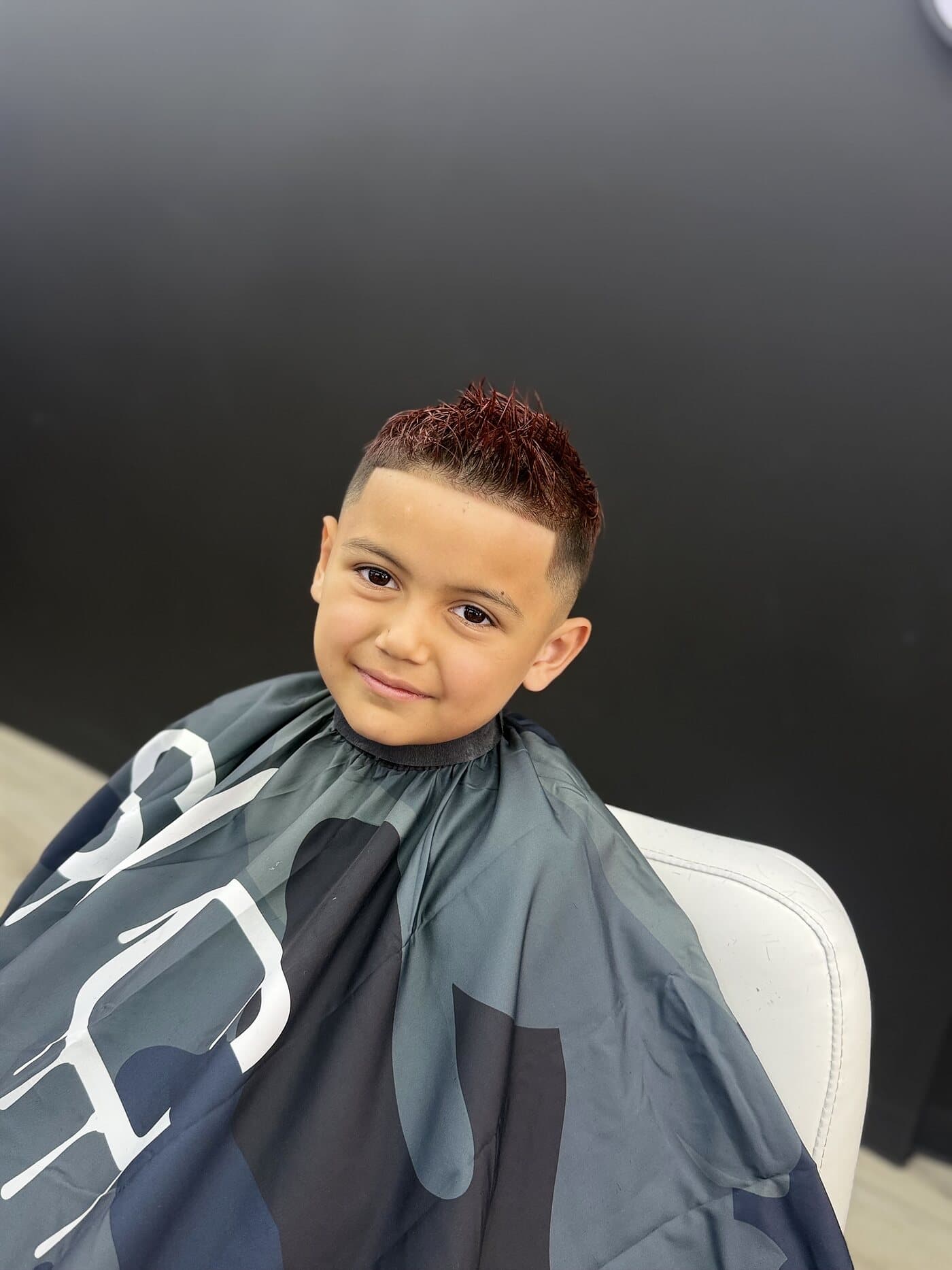 Kids haircut with a faded side and colour on top
